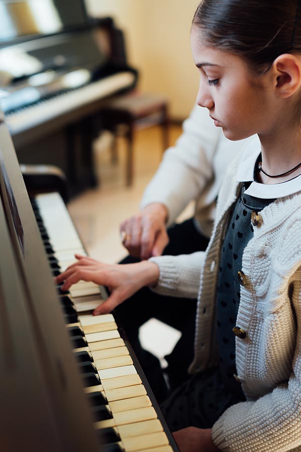 girl learning piano