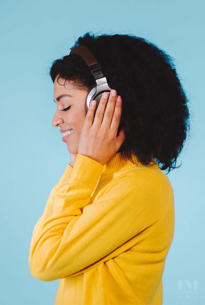 young woman listening to music with headphones